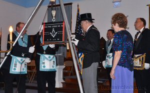 Grand Master Parson cements the stone