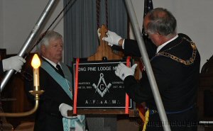 Grand Senior Warden Bruce Baker testing the stone with the Level