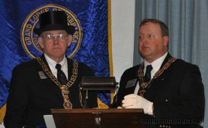 Grand Junior Warden: 'I scatter this corn as an emblem of plenty; may the blessings of bounteous heaven be showered upon us, and upon all like patriotic and important undertakings, and inspire the hearts of people with Virtue, Wisdom, and Gratitude.'